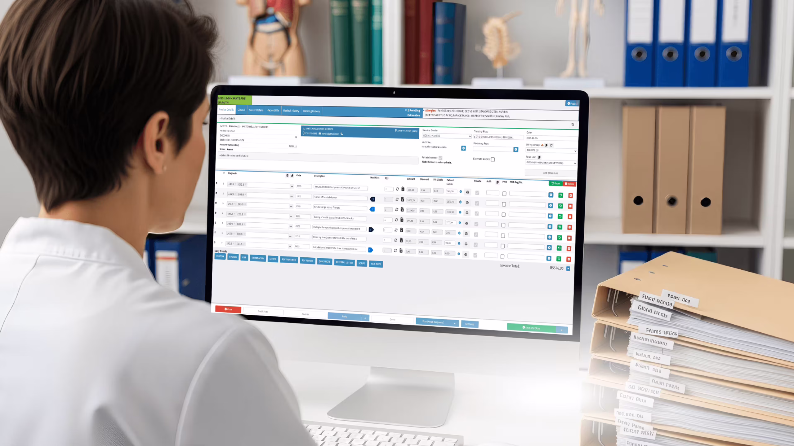 Chiropractor using billing software to manage patient invoices and claims in a clinical setting